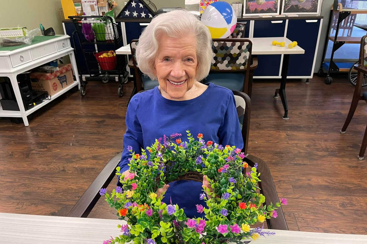 Resident being assisted by staff member at Isle at Watercrest Mansfield in Mansfield, Texas