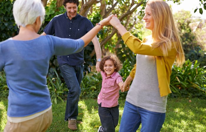 Family dancing outside at Widdicombe Place in Etobicoke, Ontario
