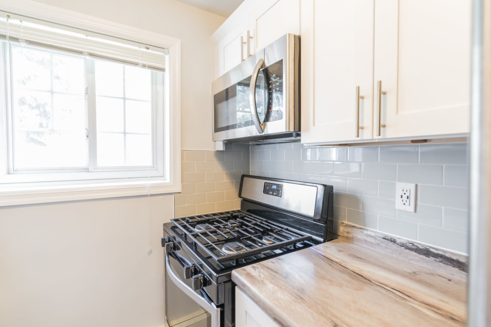 Sleek modern kitchen with stainless appliances at Eagle Rock Apartments at Carle Place in Carle Place, New York