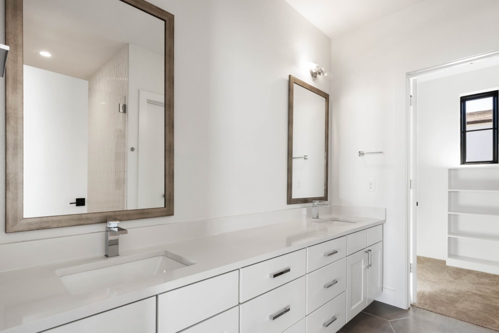 Apartment bathroom with double sink at The Collection Townhomes in Dallas, Texas