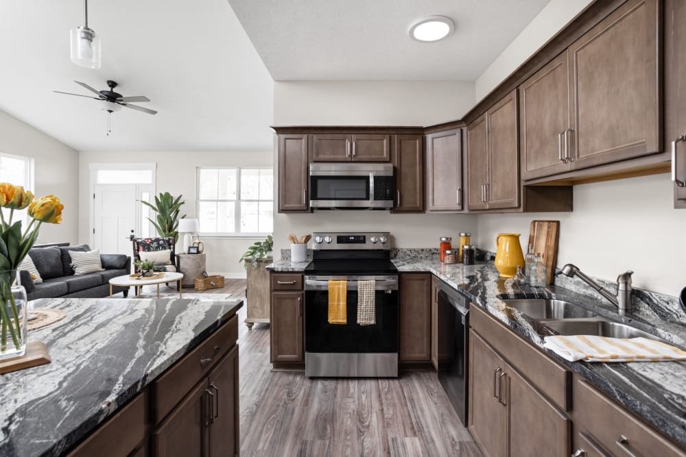 Cottage kitchen with wooden cabinets and stainless steel appliances at Randall Residence at Gateway Park in Greenfield, Indiana
