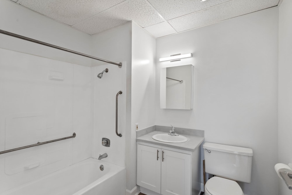 Newly renovated bathroom with tub and shower at Coeur D'Alene Plaza in Spokane, Washington