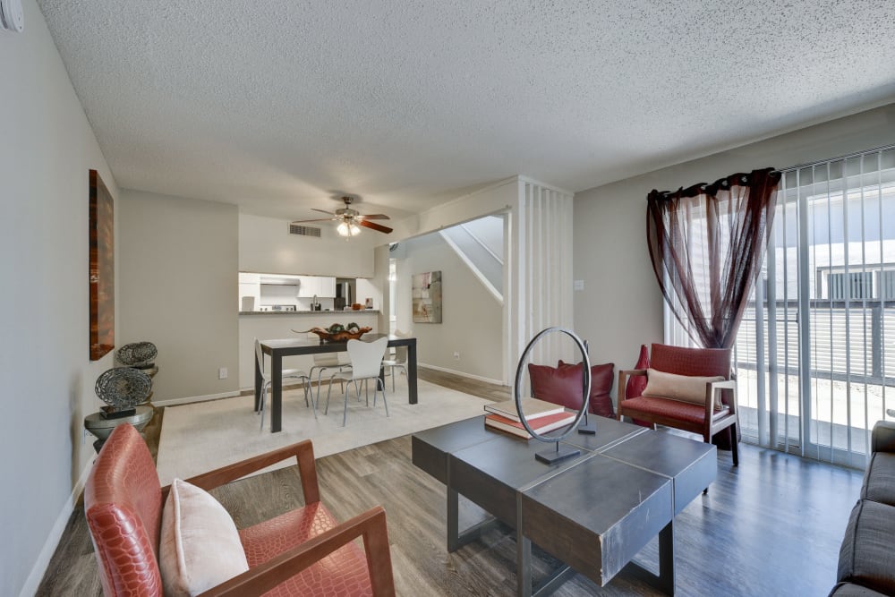 Furnished living room and dining room with a ceilnig fan at The Fredd Townhomes in San Antonio, Texas