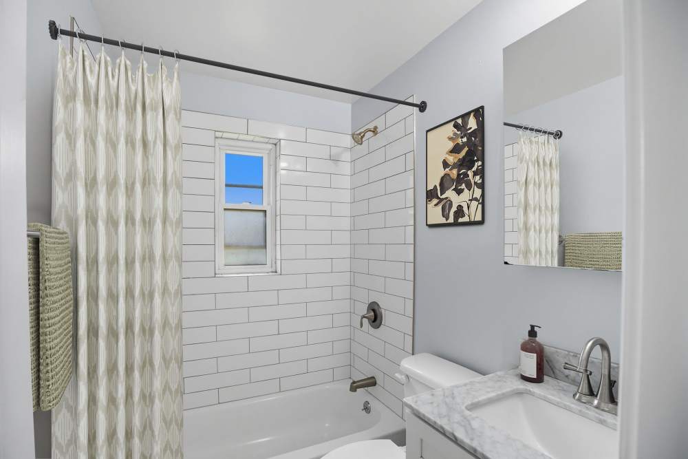 Bathroom with bathtub at Eagle Rock Apartments at Huntington Station in Huntington Station, New York