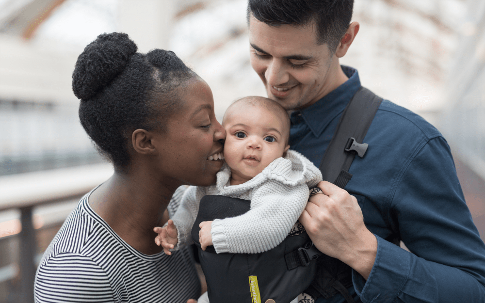 Couple out for a walk with their baby near their home at The Greens at Westgate Apartment Homes in York, Pennsylvania