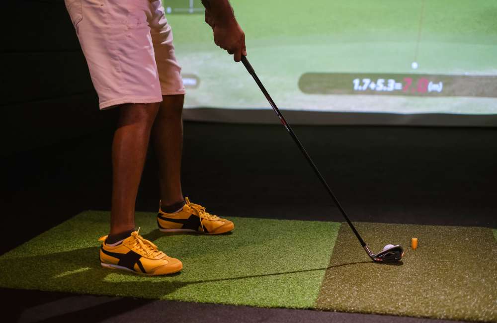 Resident using golf simulator at The Assembly in North Charleston, South Carolina