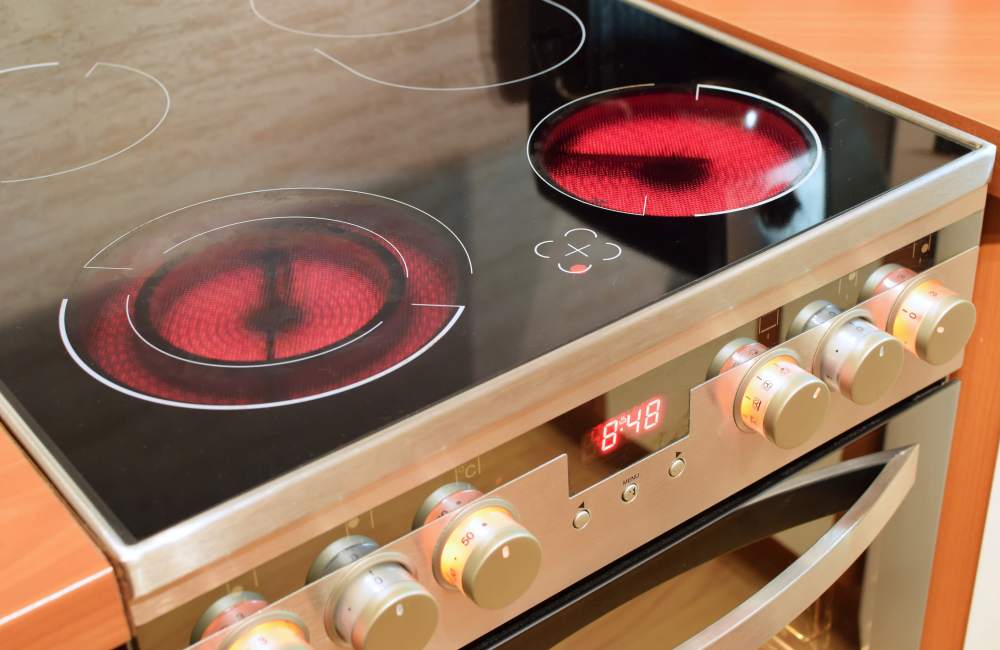 Stainless steel cooktop with illuminated burners and digital timer controls at Magnolia Crossing and Bell Ridge II in Pace, Florida