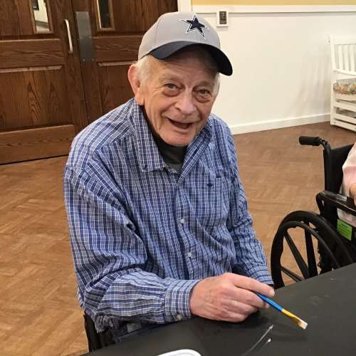 Resident showing off her painted nails at Oxford Glen Memory Care at Grand Prairie in Grand Prairie, Texas