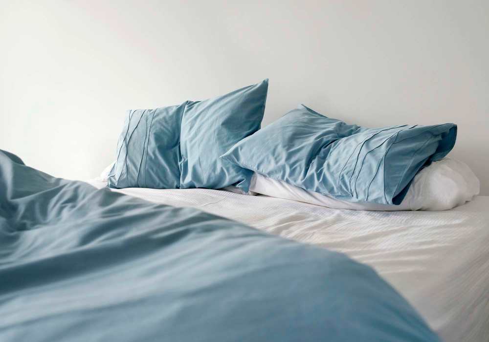 Bedroom with pillows at Mount Vernon Arms Apartments in Merrillville, Indiana