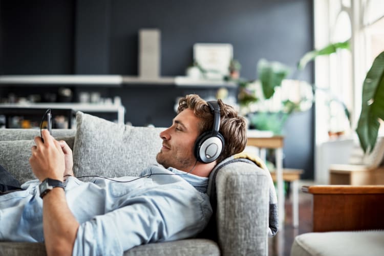 Resident relaxing at home with headphones on at Innova in Novi, Michigan