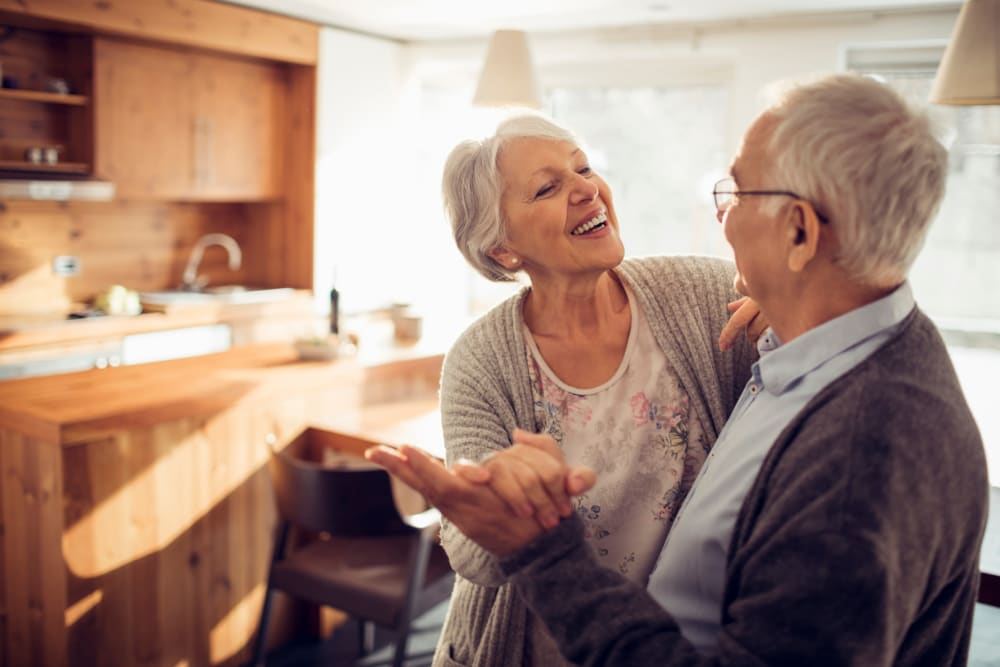 Two residents dancing in their apartment at Quail Park of Granbury in Granbury, Texas