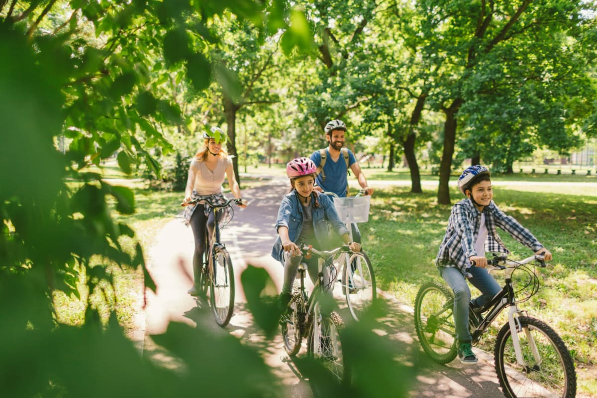 A family rides bikes in a park near Willow Creek, San Jose, California