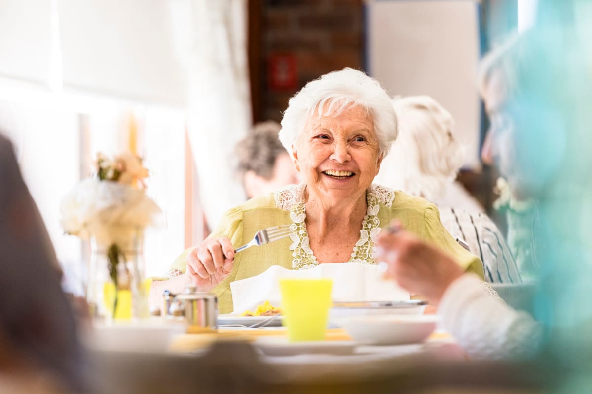 A memory care resident in the dining hall at Oxford Glen Memory Care at Grand Prairie in Grand Prairie, Texas