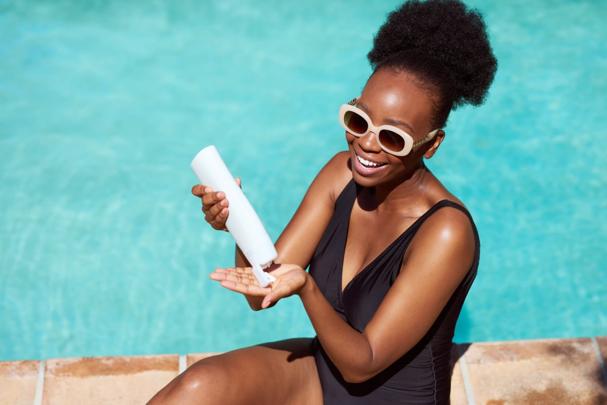 Resident applying sunscreen on the pool facility at Magnolia Row in Oklahoma City, Oklahoma