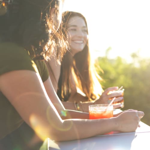 Resident friends enjoying drinks outside on a beautiful day at Castilian in Concord, California