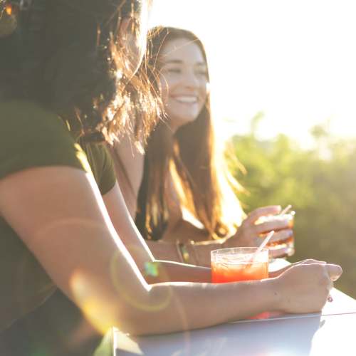 Resident friends enjoying drinks outside on a beautiful day at Town Center Crossing in Kingwood, Texas