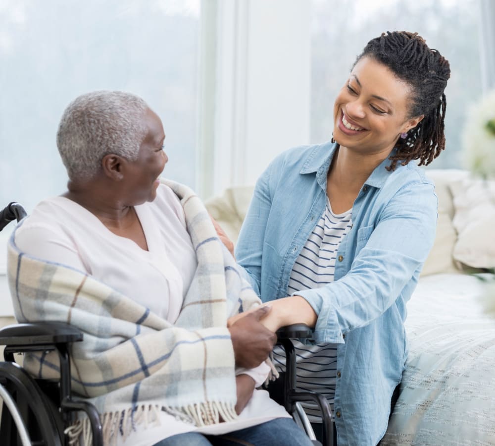 A resident talking to a care team member at Windchime of Chico in Chico, California. 