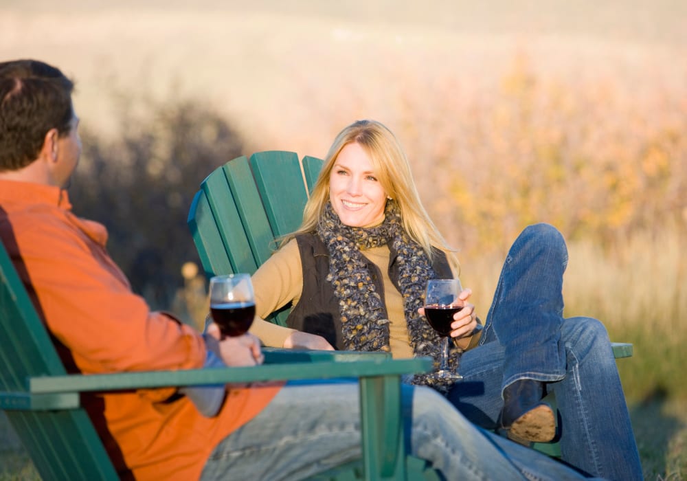 Couple in Adirondack chairs drinking wine at Kelson Row at Rocky Hill in Rocky Hill, Connecticut