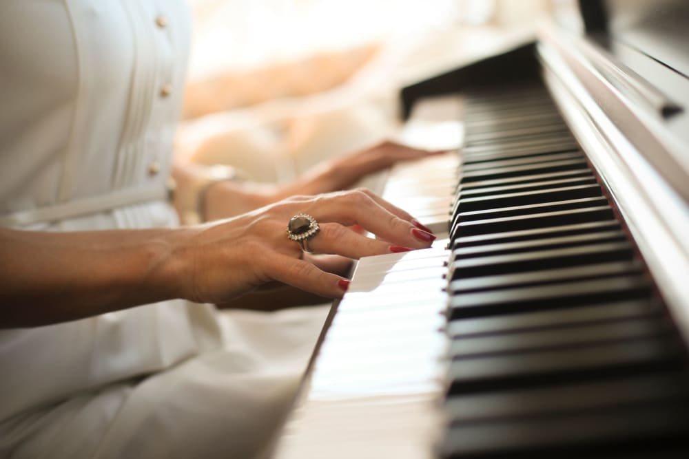 senior resident playing the piano at The Vista in Esquimalt, British Columbia.