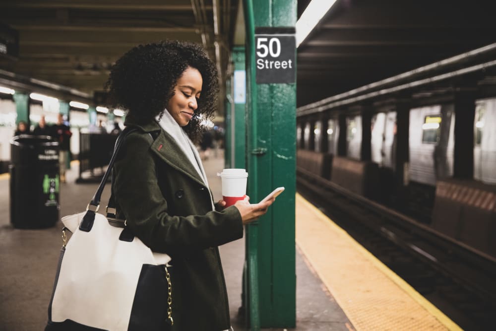 Resident waiting for public transportation at The Ellington in New York, New York