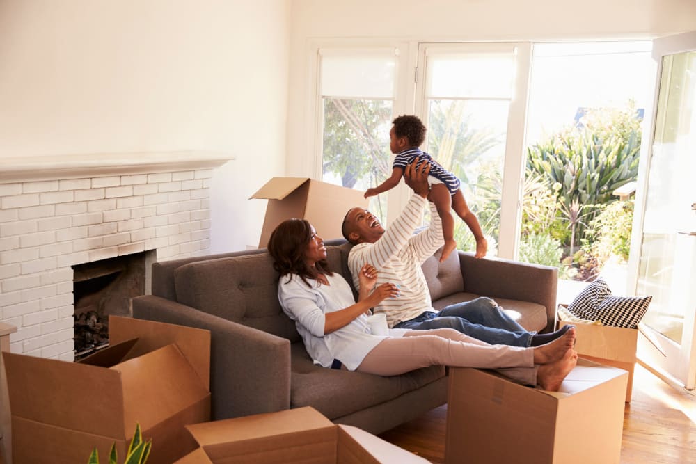 A family packing boxes in their home near modSTORAGE Skypark in Monterey, California