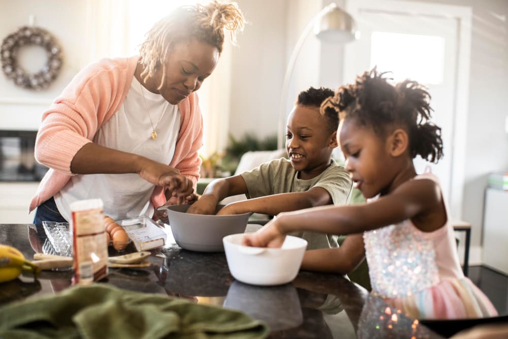Resident preparing a meal with her children at Sandpiper Apartments in Seatac, Washington