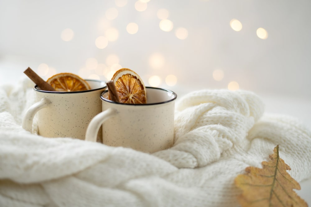 Stock photo of two coffee cups on the comfy bed