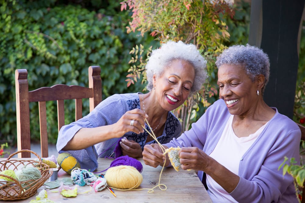 Two residents knitting together at Gilfield Park in Charlotte, North Carolina