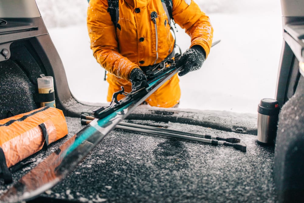 A customer putting skis in a car near Storage Star DeZavala in San Antonio, Texas