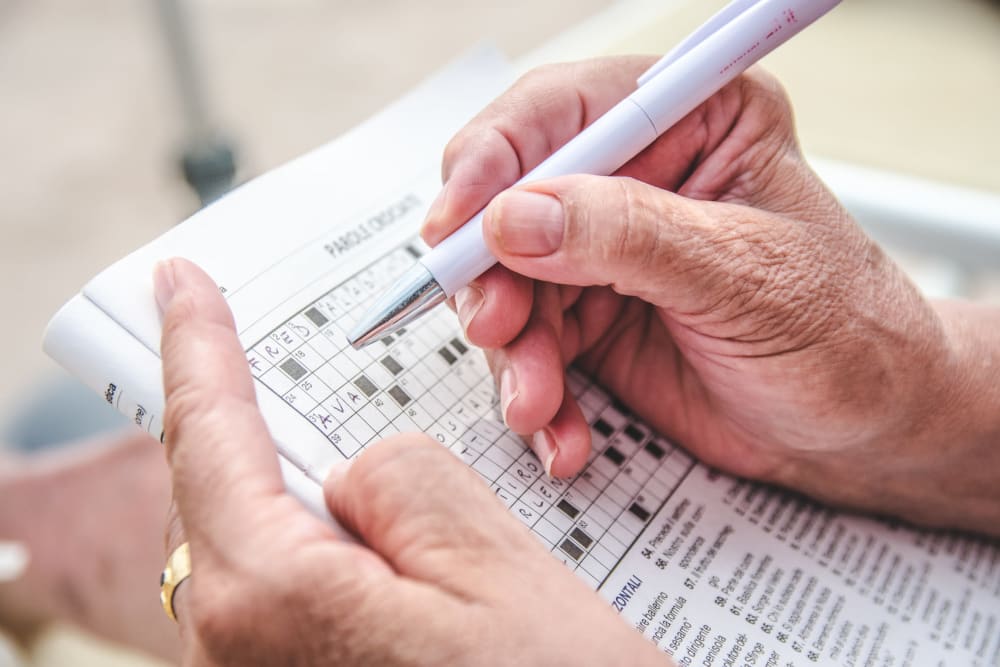 Working on a crossword puzzle at The Heritage of Meyerland in Houston, Texas