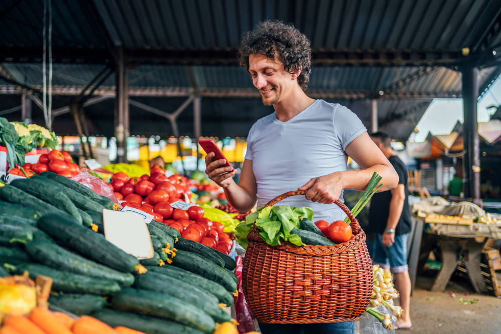 A man shopping for produce at an outdoor market at Dolphin Marina Apartments in Marina Del Rey, California