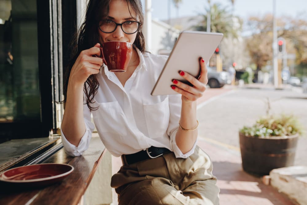 Woman enjoying some coffee at Regency at Johns Creek Walk in John's Creek, Georgia