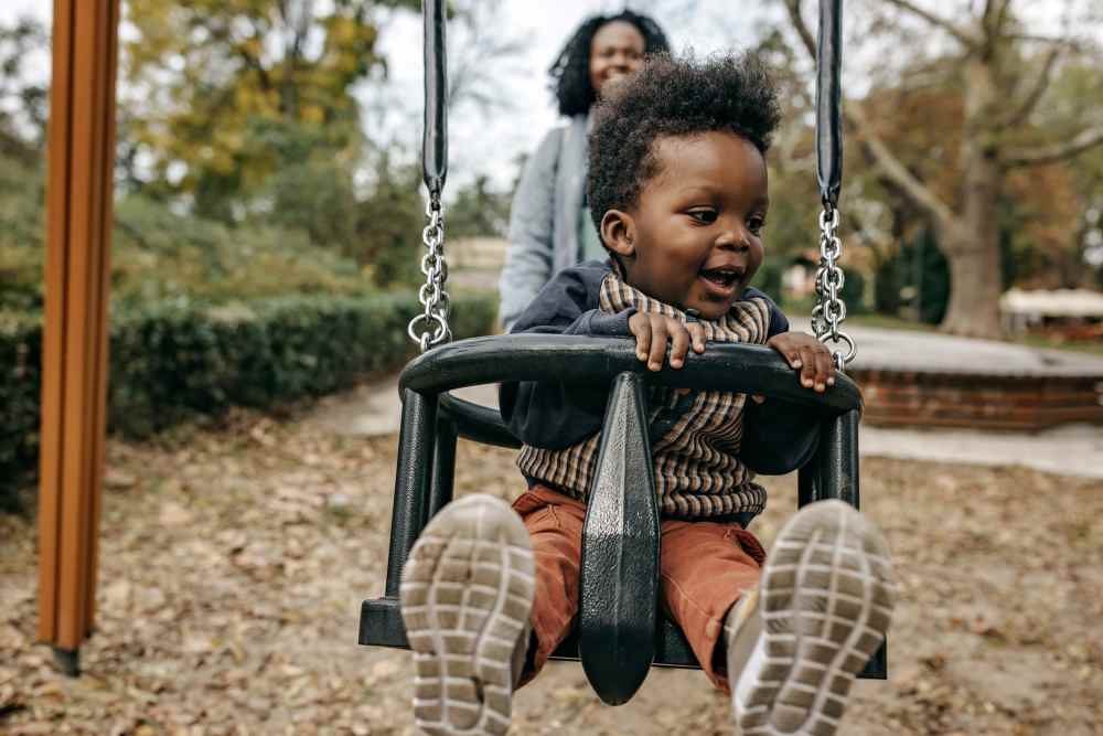 Mom and child playing on a swing near Featherstone in Durham, North Carolina