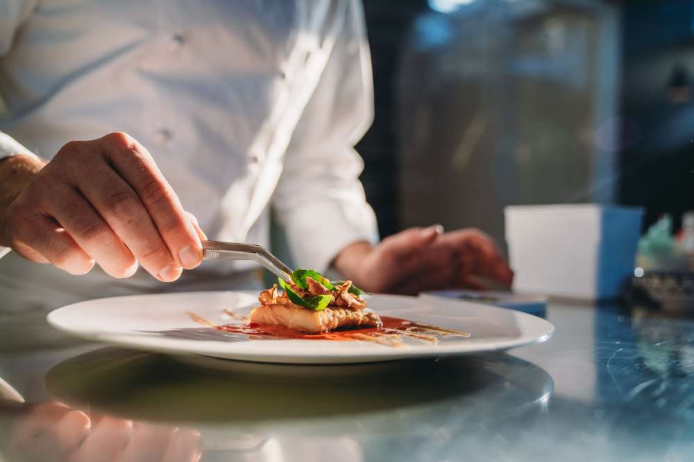 Chef plating a dish at Clearwater at The Heights in Houston, Texas