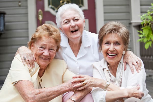 Three residents laughing together at Heritage Senior Living in Blue Bell, Pennsylvania