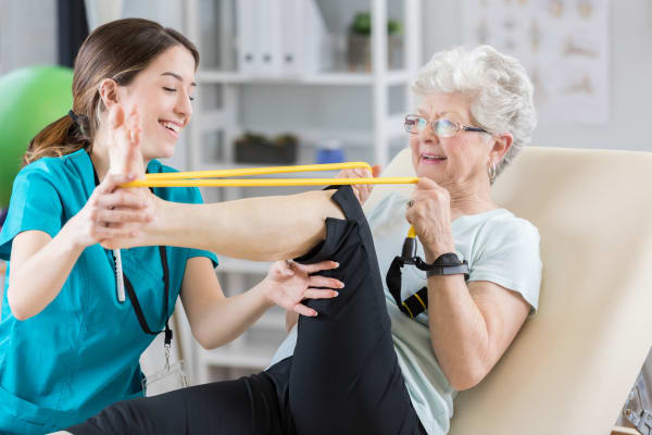 Nurse helping a woman stretch at Westmont Village in Riverside, California