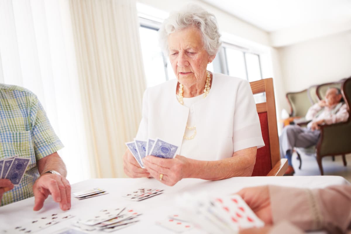 Resident playing a card game at Avenir Senior Living in Scottsdale, Arizona. 