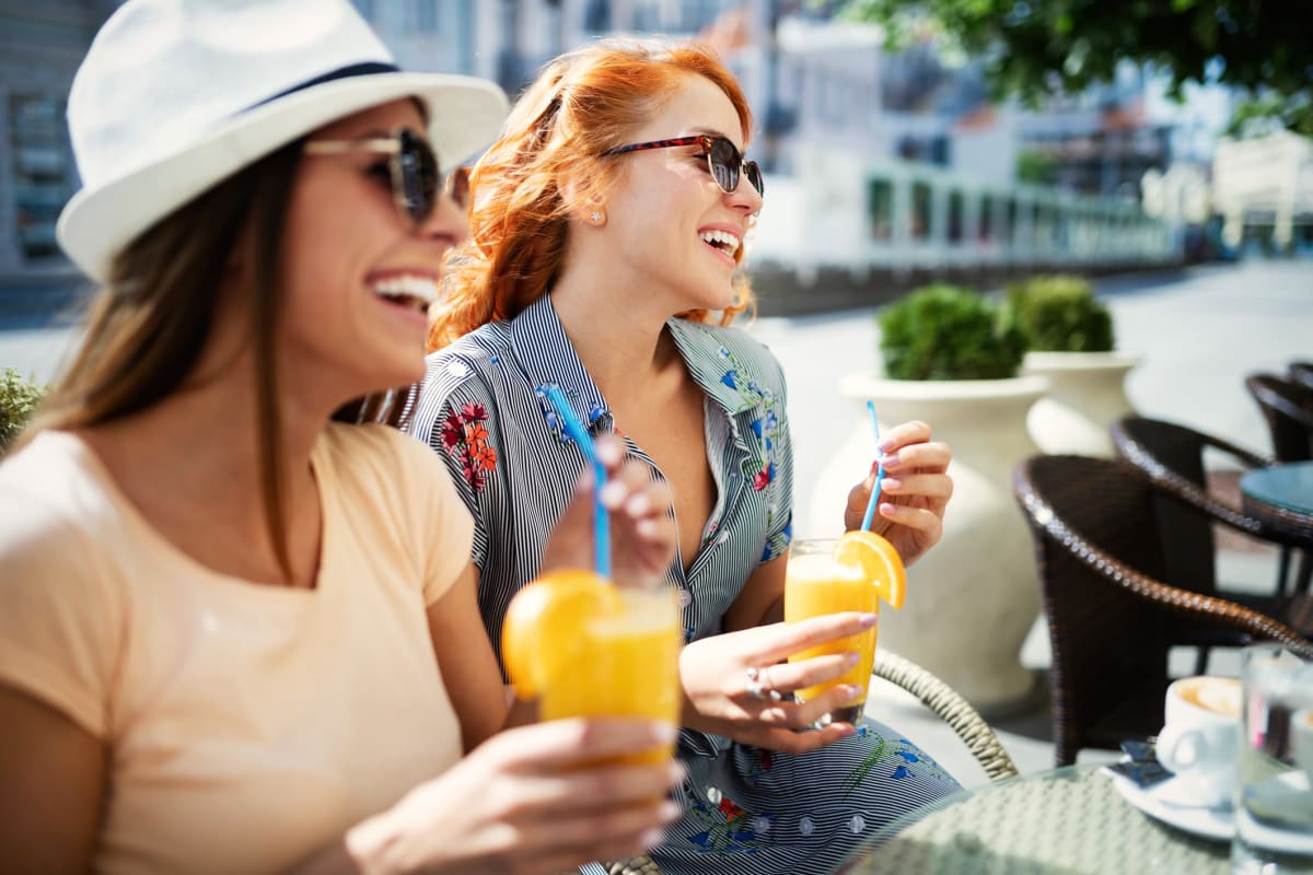 Two friends enjoying some delicious orange juice near BB Living Murphy Creek in Aurora, Colorado