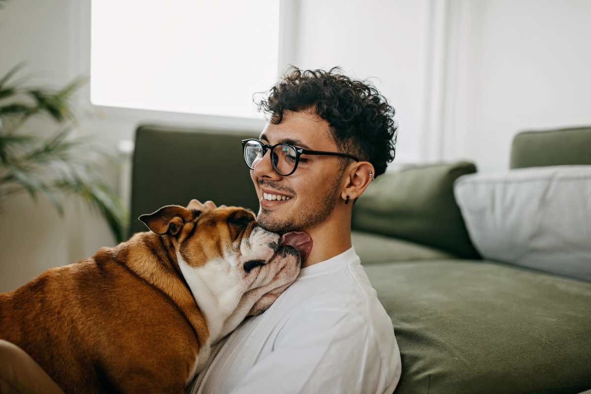 Resident cuddling with his pup in their new home at The Standard at Pinestone in Travelers Rest, South Carolina