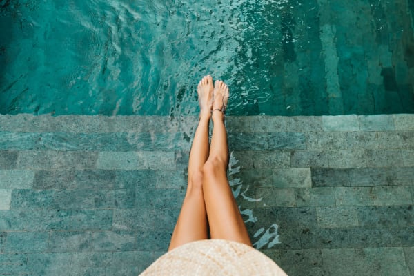 Resident dipping her toes in the pool at Sterling Pointe Apartments in Davis, California