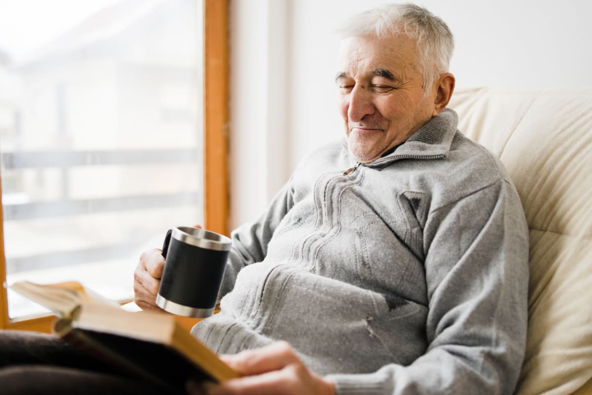 A resident using a smart phone at Oxford Glen Memory Care at Grand Prairie in Grand Prairie, Texas