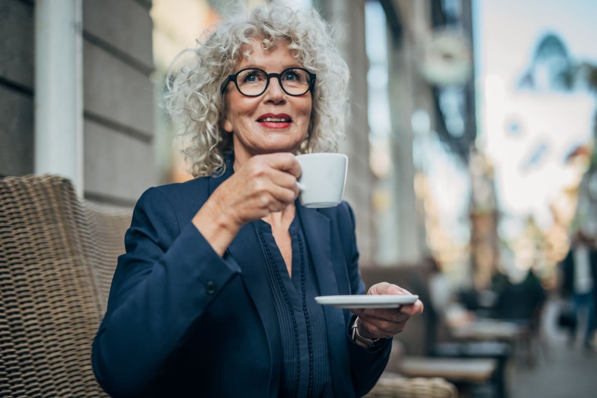 Resident sitting outside drinking coffee at Sky Vista in Mesa, Arizona