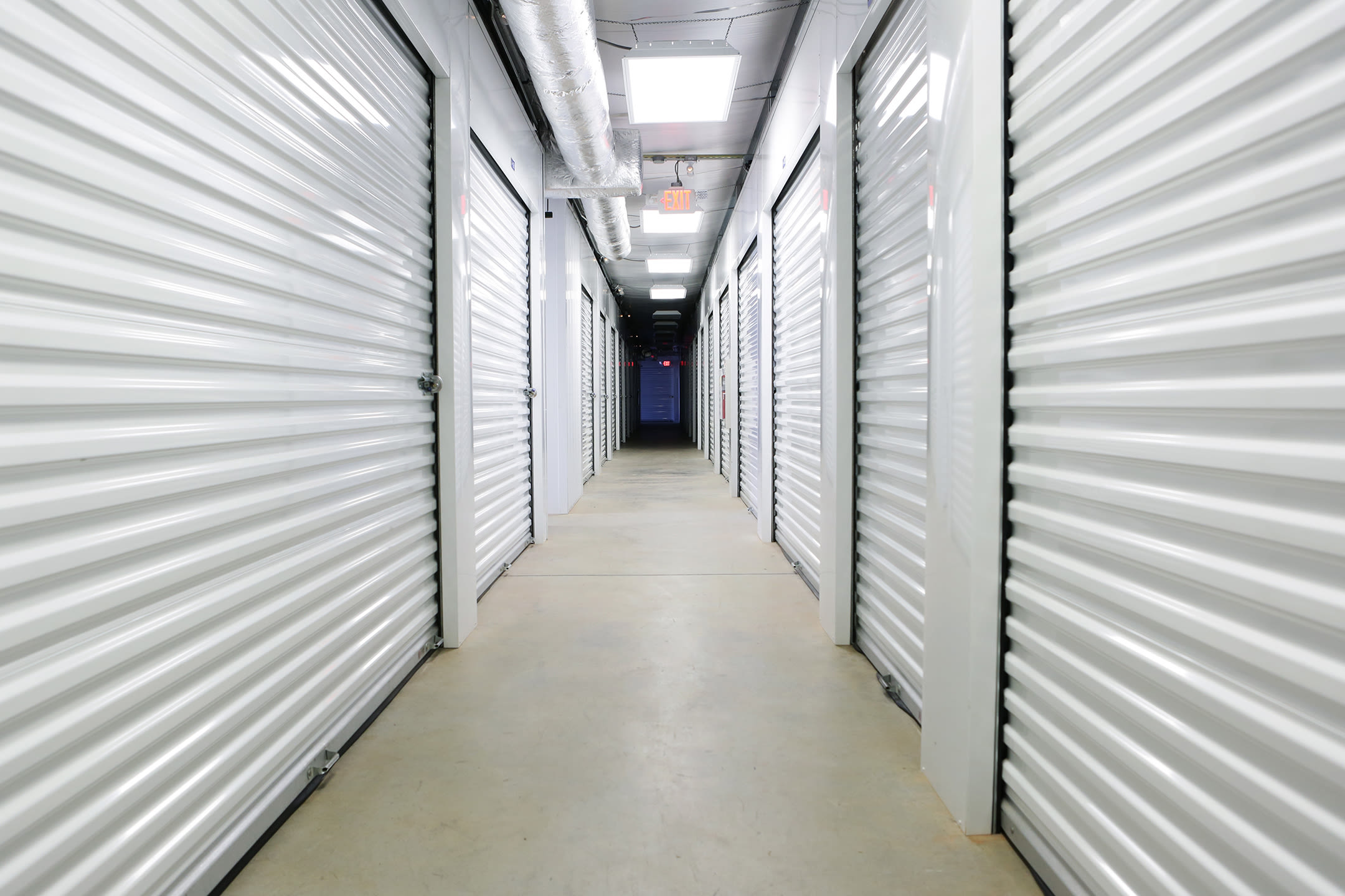 Storage units with white doors at Midgard Self Storage in Wilmington, North Carolina