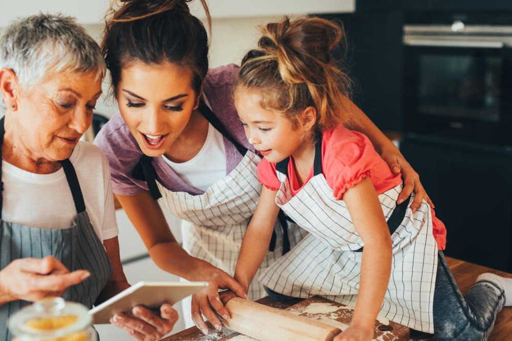 Family cooking together in their fully equipped kitchen at The Docks Apartments & Townhomes in Pittsburgh, Pennsylvania