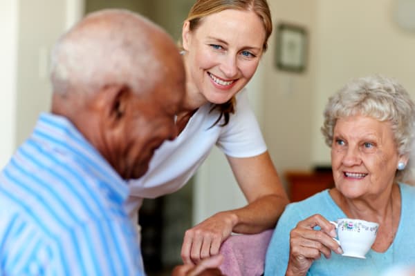 Caregiver helping residents at The Whitcomb Senior Living Tower in St. Joseph, Michigan