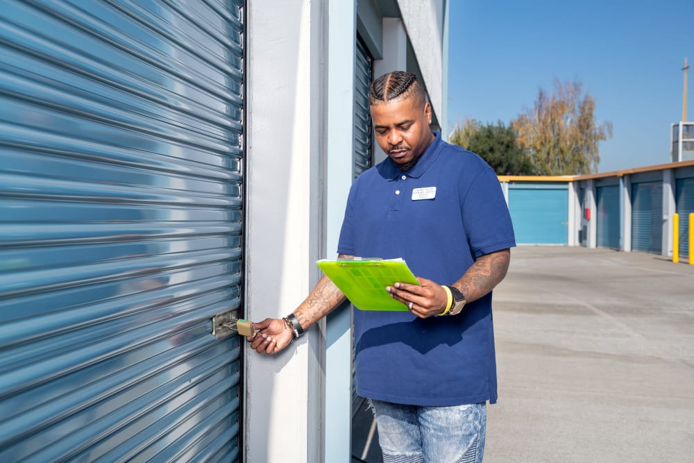An employee checks the lock at Hayward Storage LLC in Hayward, California
