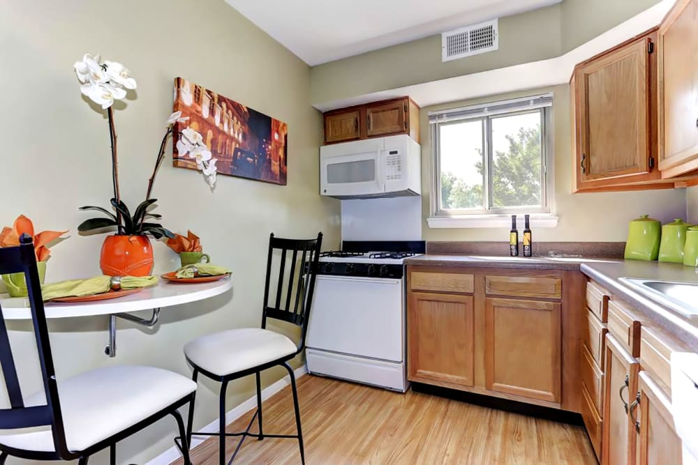 Model kitchen and dining table at Hamilton Springs Apartments in Baltimore, Maryland