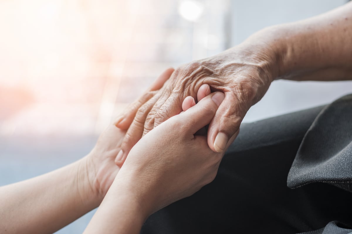 Holding hands at Lighthouse Memory Care in Anacortes, Washington