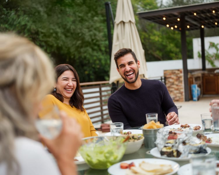 Residents eating food together outdoors near Innova in Novi, Michigan