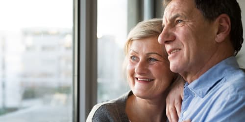 Couple looking out a window together at Laguna Senior in Los Angeles, California